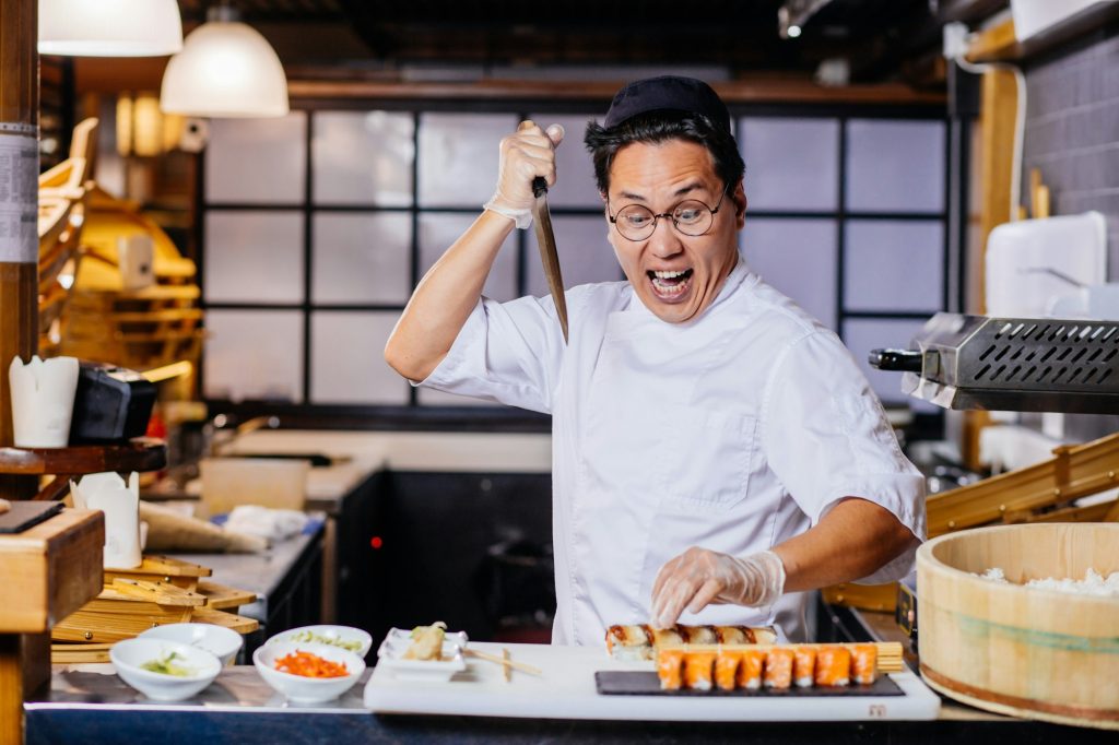 killer of sushi. funny chef having fun in sushi cafe