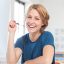 portrait-of-happy-young-woman-at-her-desk-in-a-1-1.jpg